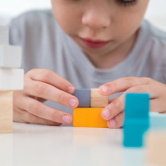 Child playing with Plant Toys 3D Puzzle Cube in Yellow, Grey and Blue