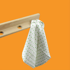 Creamore Mill Tea Towel Holder in Oak with green polka dot towel hanging from it. 